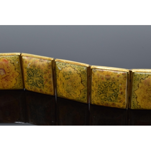 414 - Yellow metal and oriental panel bracelet. 19.5cm long.