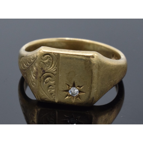 426 - 9ct gold signet ring set with diamond chip and engraved decoration. 7.1 grams. Size W.