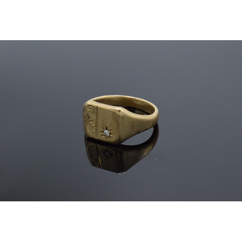 426 - 9ct gold signet ring set with diamond chip and engraved decoration. 7.1 grams. Size W.