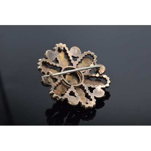 456 - 9ct gold and garnet set brooch, not hallmarked but tested as 9ct gold, 9.9g, 35mm wide.