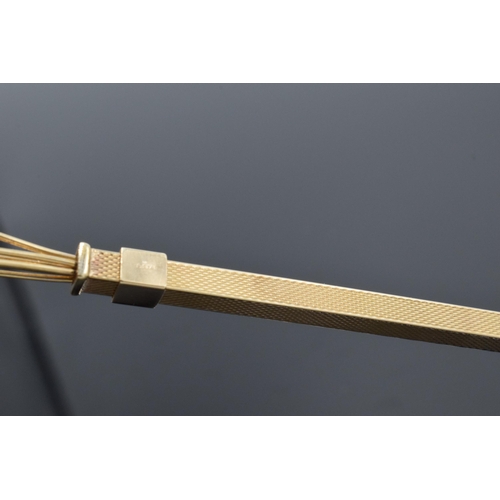 465A - 9ct gold mechanical cocktail stirrer with engineered decoration, 6.5 grams gross weight.