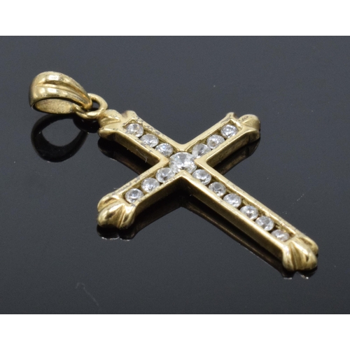 486 - 9ct gold crucifix pendant set with CZ stones. 0.8 grams. 20mm tall.