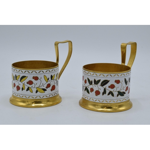 493 - A pair of Soviet tea glass holders with enamel decoration (2). 9cm tall.