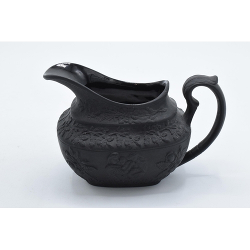 82 - A trio of 19th century black basalt cream jugs to include one with floral impressed number '34' to b... 