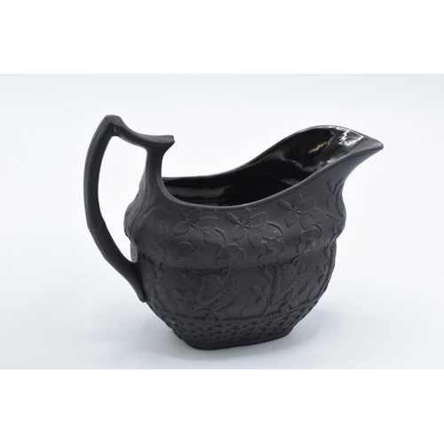 83 - A trio of early to mid 19th century black basalt cream jugs to include 2 examples with detailed flor... 