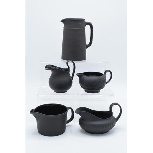 88 - A collection of mainly 19th century Wedgwood black basalt jugs of varying forms to include a taller ... 