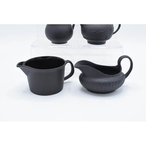 88 - A collection of mainly 19th century Wedgwood black basalt jugs of varying forms to include a taller ... 