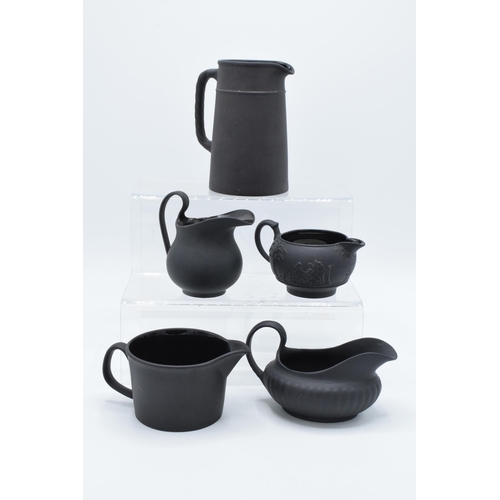 88 - A collection of mainly 19th century Wedgwood black basalt jugs of varying forms to include a taller ... 