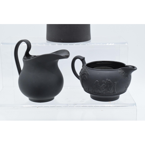 88 - A collection of mainly 19th century Wedgwood black basalt jugs of varying forms to include a taller ... 