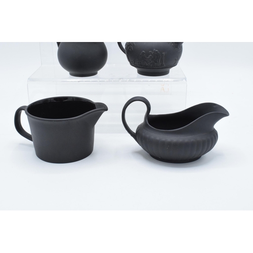 88 - A collection of mainly 19th century Wedgwood black basalt jugs of varying forms to include a taller ... 