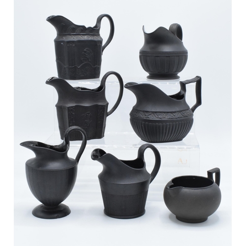 89 - A collection of mainly 19th century black basalt cream jugs to include named examples such as Wedgwo... 