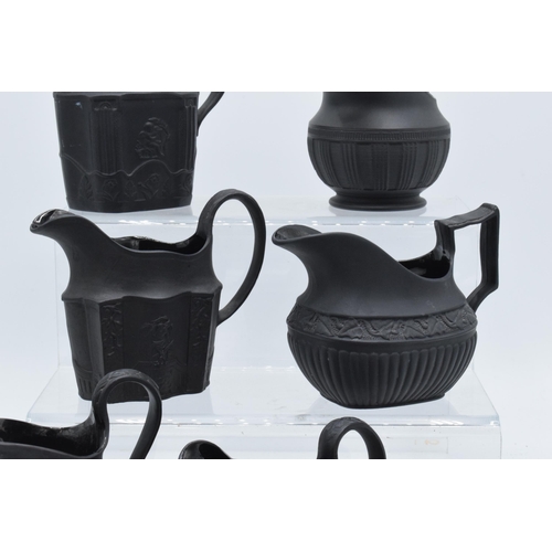 89 - A collection of mainly 19th century black basalt cream jugs to include named examples such as Wedgwo... 