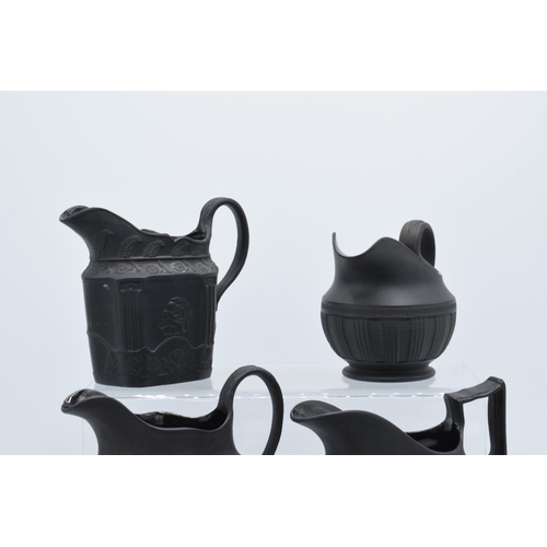 89 - A collection of mainly 19th century black basalt cream jugs to include named examples such as Wedgwo... 