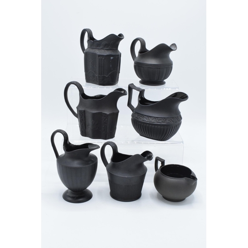 89 - A collection of mainly 19th century black basalt cream jugs to include named examples such as Wedgwo... 