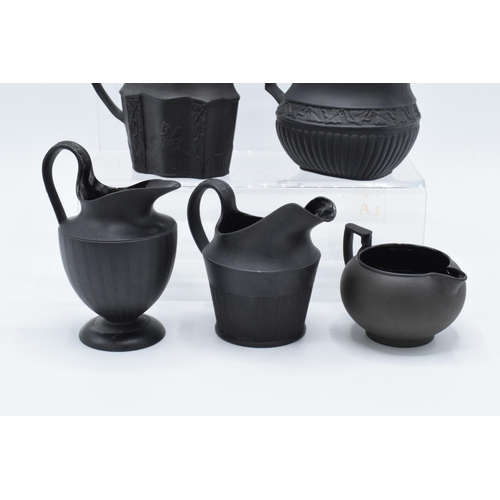 89 - A collection of mainly 19th century black basalt cream jugs to include named examples such as Wedgwo... 