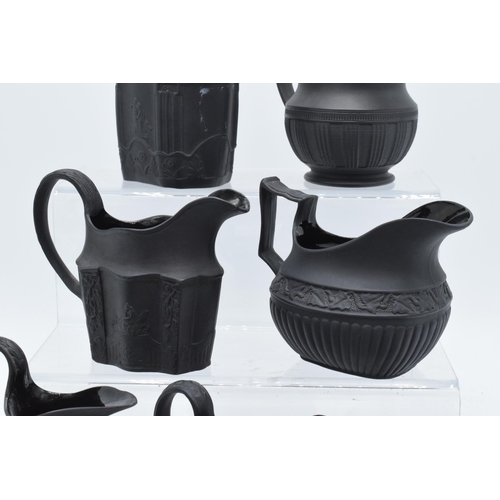 89 - A collection of mainly 19th century black basalt cream jugs to include named examples such as Wedgwo... 