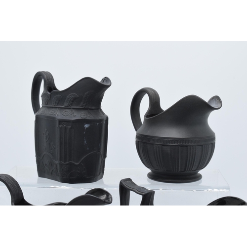 89 - A collection of mainly 19th century black basalt cream jugs to include named examples such as Wedgwo... 