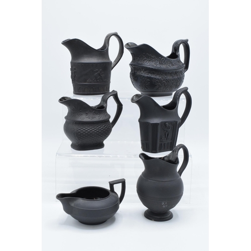 90 - A collection of mainly 19th century black basalt cream jugs to include a shallow Wedgwood example, j... 