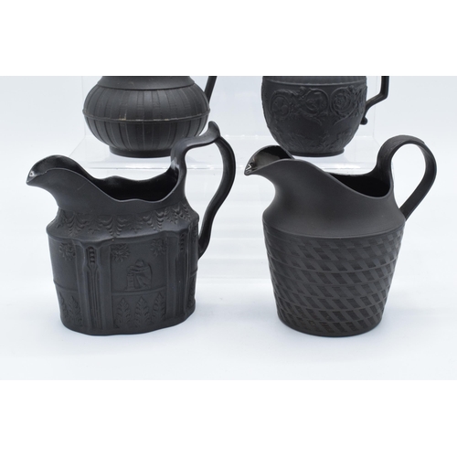 91 - A collection of mainly 19th century black basalt cream jugs to include two Wedgwood examples, one wi... 