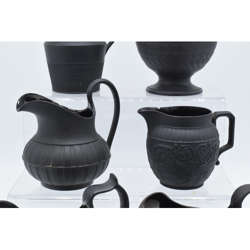 91 - A collection of mainly 19th century black basalt cream jugs to include two Wedgwood examples, one wi... 