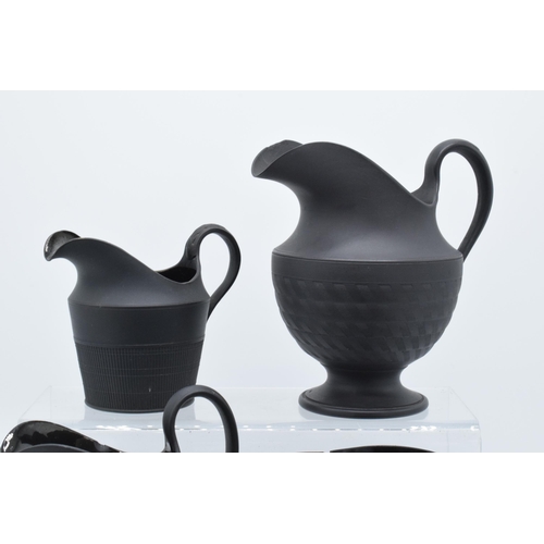 91 - A collection of mainly 19th century black basalt cream jugs to include two Wedgwood examples, one wi... 