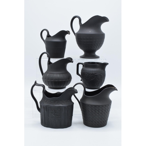 91 - A collection of mainly 19th century black basalt cream jugs to include two Wedgwood examples, one wi... 