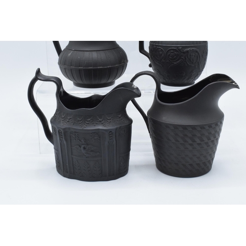 91 - A collection of mainly 19th century black basalt cream jugs to include two Wedgwood examples, one wi... 