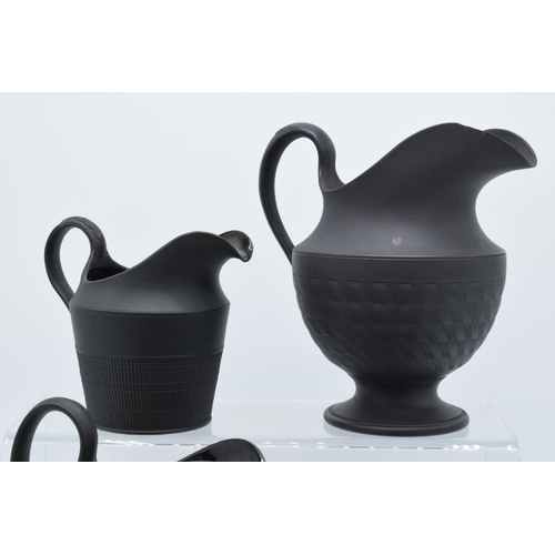 91 - A collection of mainly 19th century black basalt cream jugs to include two Wedgwood examples, one wi... 