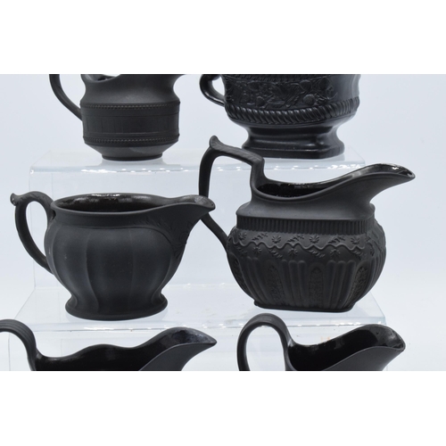 92 - A collection of mainly 19th century black basalt cream jugs to include a Wedgwood example in a modes... 