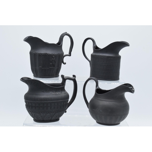 94 - A black basalt cream jug circa 1795 - 1800, attributed to Wilson, together with 3 others, the first ... 