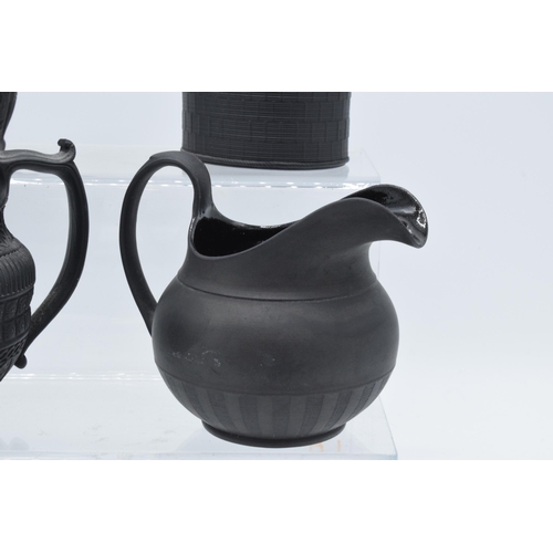 94 - A black basalt cream jug circa 1795 - 1800, attributed to Wilson, together with 3 others, the first ... 