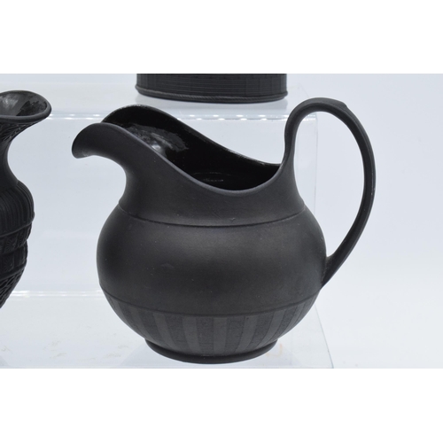 94 - A black basalt cream jug circa 1795 - 1800, attributed to Wilson, together with 3 others, the first ... 