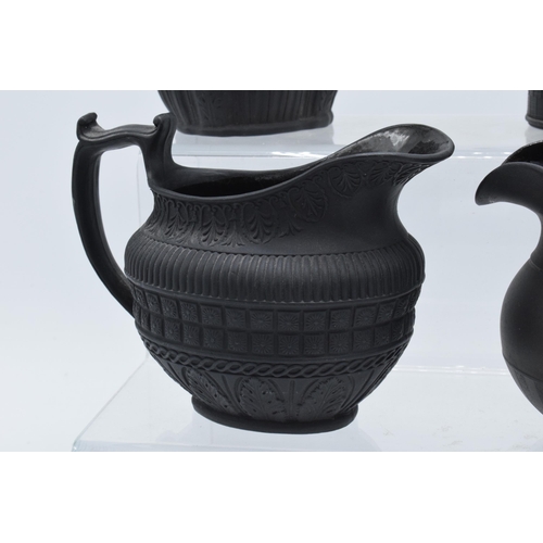 94 - A black basalt cream jug circa 1795 - 1800, attributed to Wilson, together with 3 others, the first ... 