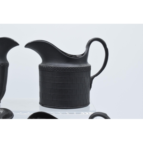 94 - A black basalt cream jug circa 1795 - 1800, attributed to Wilson, together with 3 others, the first ... 