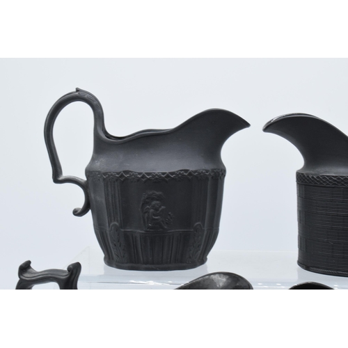 94 - A black basalt cream jug circa 1795 - 1800, attributed to Wilson, together with 3 others, the first ... 