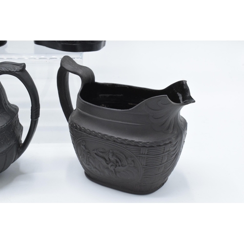 95 - A collection of early 19th century black basalt jugs to include a Wedgwood cream jug along with 7 ot... 