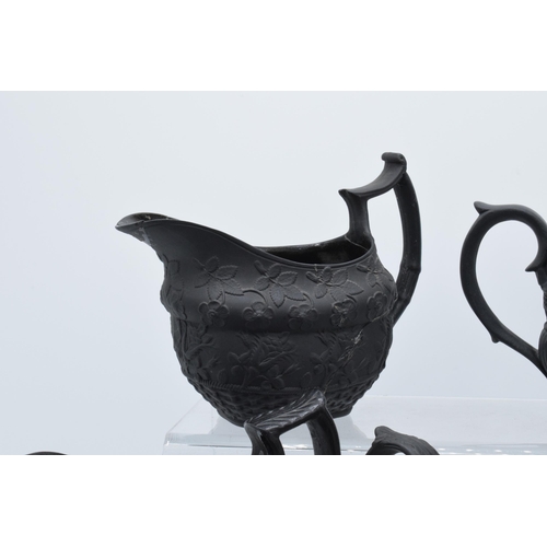 95 - A collection of early 19th century black basalt jugs to include a Wedgwood cream jug along with 7 ot... 