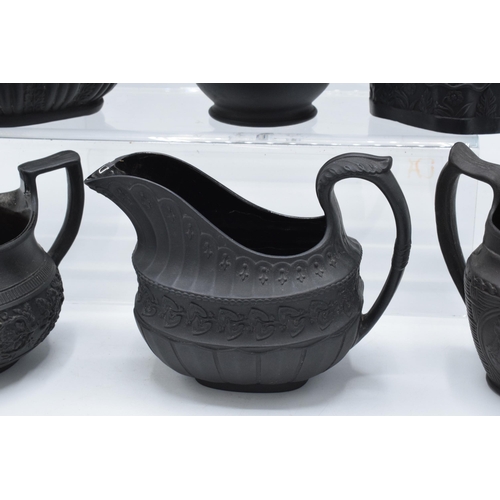 95 - A collection of early 19th century black basalt jugs to include a Wedgwood cream jug along with 7 ot... 