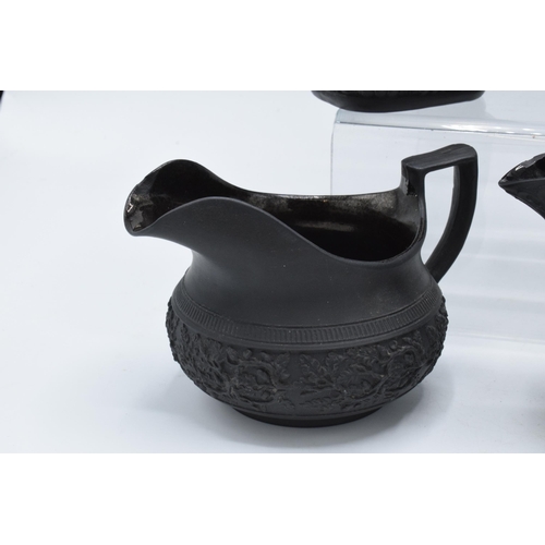 95 - A collection of early 19th century black basalt jugs to include a Wedgwood cream jug along with 7 ot... 