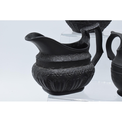 95 - A collection of early 19th century black basalt jugs to include a Wedgwood cream jug along with 7 ot... 