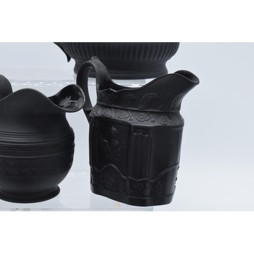 95 - A collection of early 19th century black basalt jugs to include a Wedgwood cream jug along with 7 ot... 