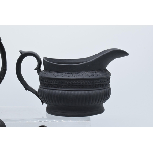 95 - A collection of early 19th century black basalt jugs to include a Wedgwood cream jug along with 7 ot... 