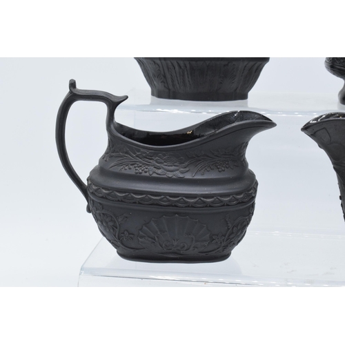 96 - A collection of black basalt milk jugs, circa 1800-1810, to include an oval example sprigged with 'H... 