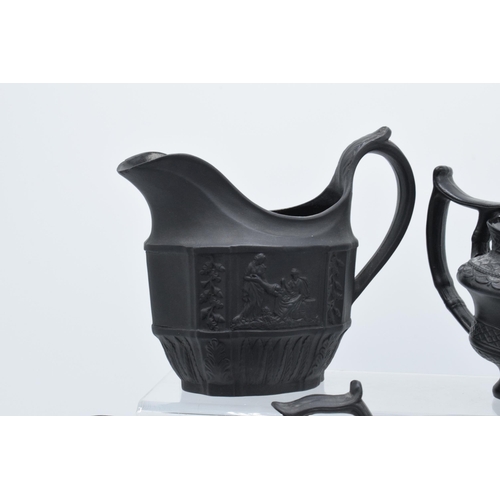 96 - A collection of black basalt milk jugs, circa 1800-1810, to include an oval example sprigged with 'H... 