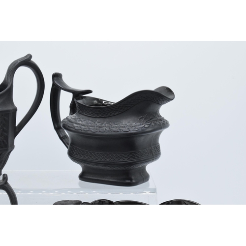 96 - A collection of black basalt milk jugs, circa 1800-1810, to include an oval example sprigged with 'H... 