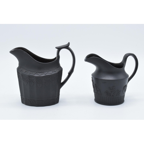 99 - A pair of late 18th century basalt milk jugs, one hvaing moulded faceted oval body and of decorative... 