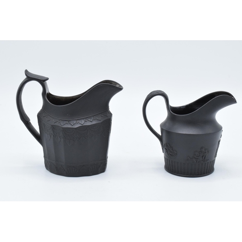 99 - A pair of late 18th century basalt milk jugs, one hvaing moulded faceted oval body and of decorative... 