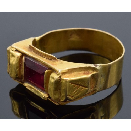 454 - High carat medieval gold ring (22ct +) set with a red stone. 4.8 grams gross weight. UK size V/W.