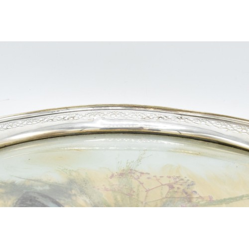 370 - An unusual sterling silver circular tray with pierced edges decorated with dried glass and foliage. ... 