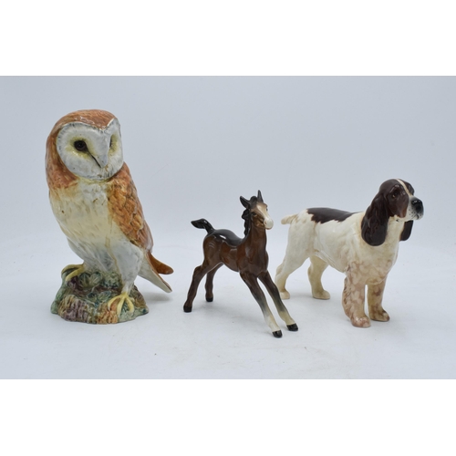 110 - A trio of Beswick animals to include barn owl 1046, large brown outstretched foal and cocker spaniel... 